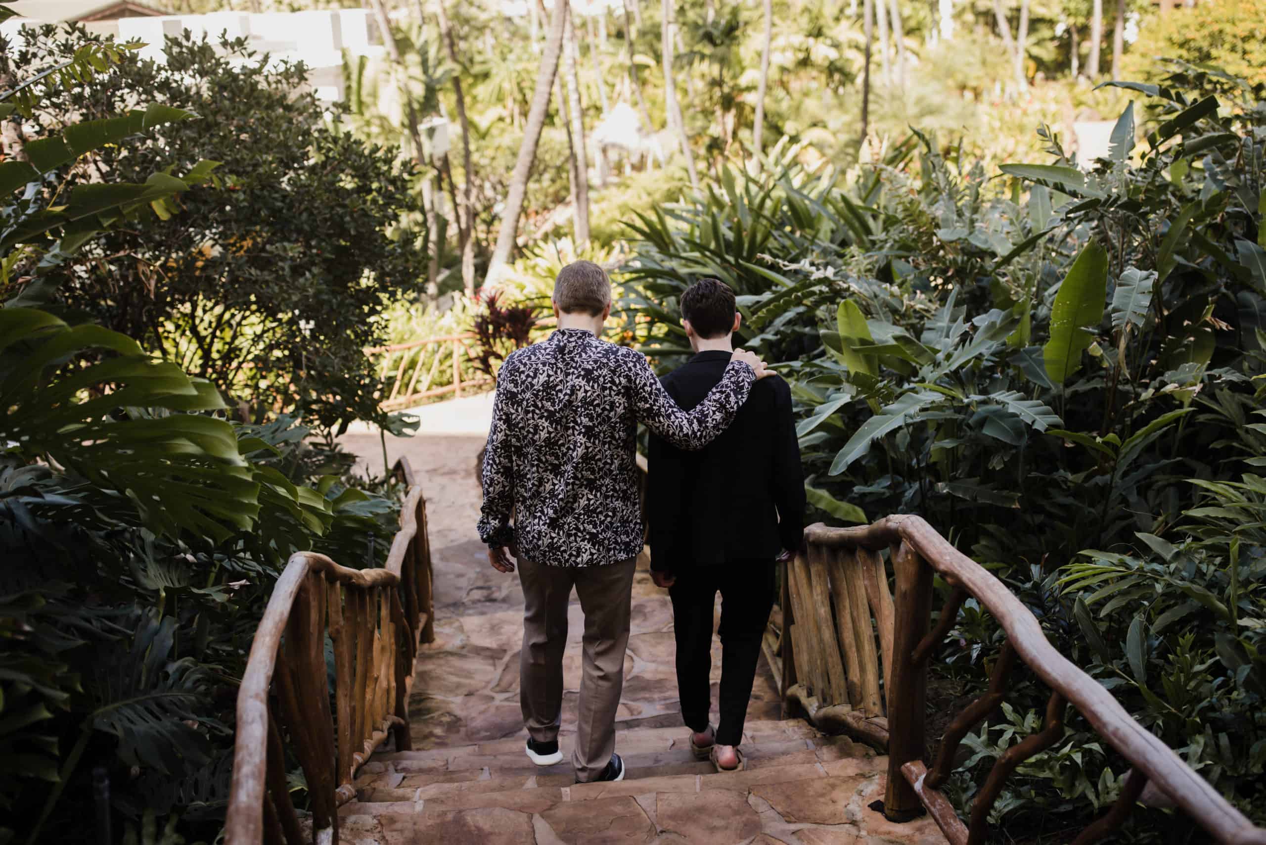 A couple is walking down the stairs at a resort, ready to elope in Maui.