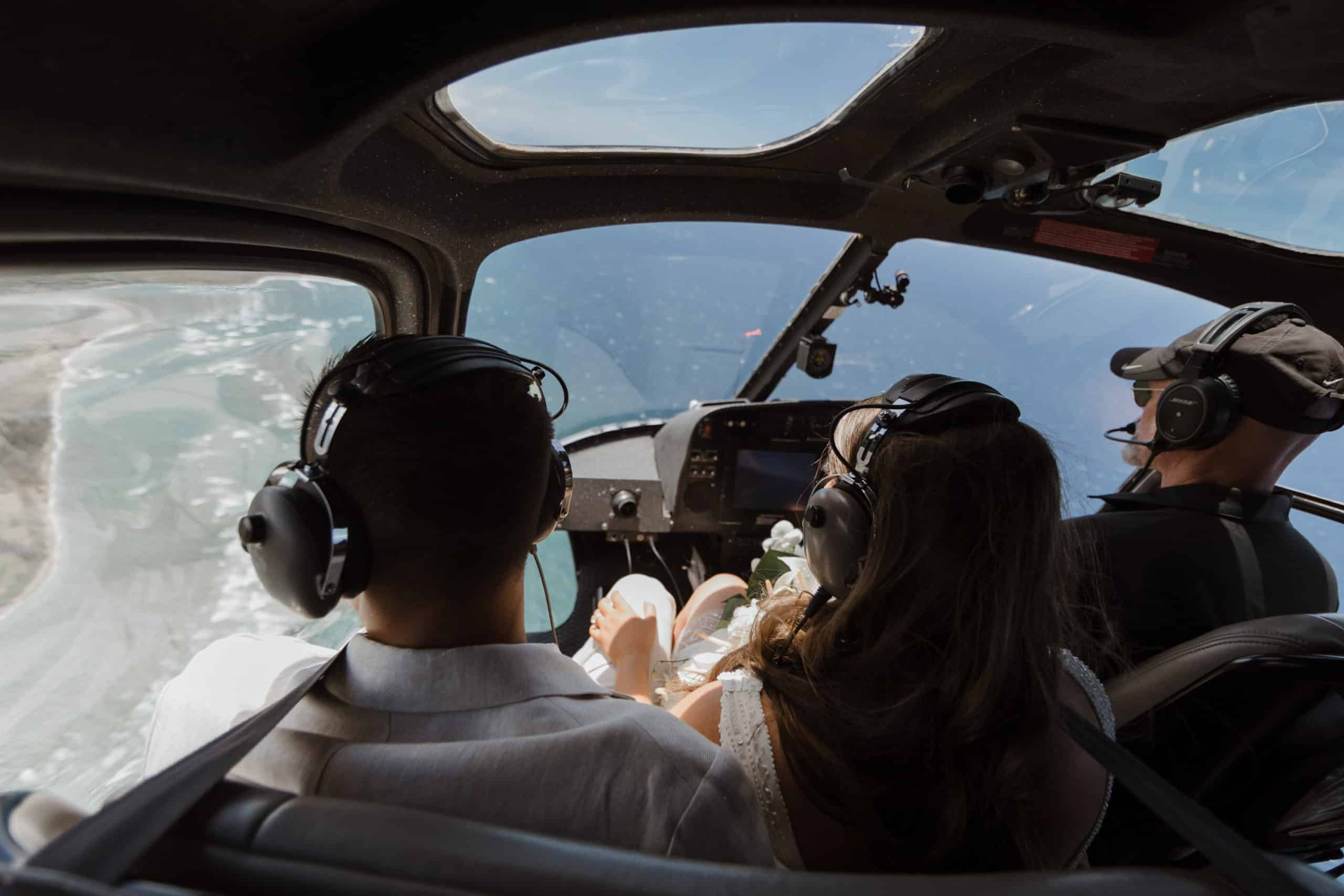 A couple is taking a helicopter tour while they elope in Maui.