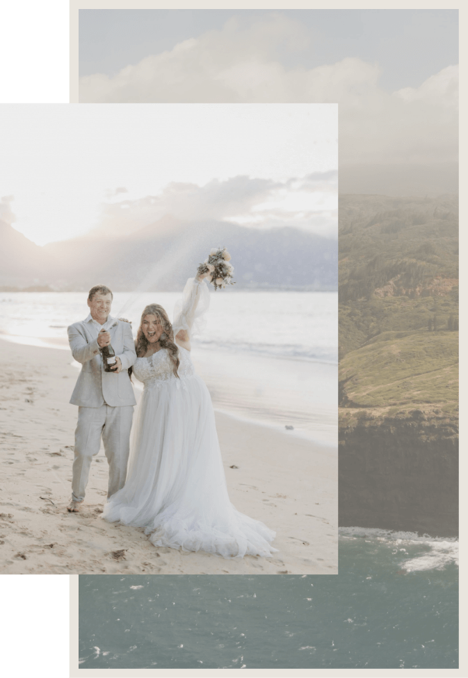 A bride and groom celebrate on a beach at sunset. The groom holds a bottle of champagne, and the bride lifts a bouquet. Hills and the ocean are visible in the background.