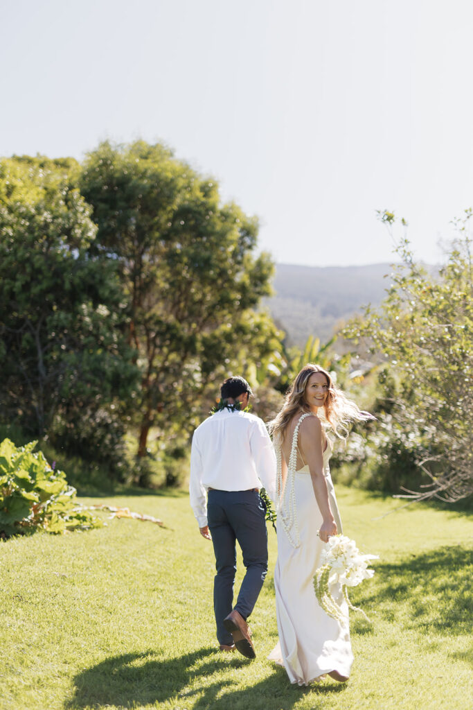 Roam Elopements, Maui Elopements, Bride and groom walking on lawn, elopement location.