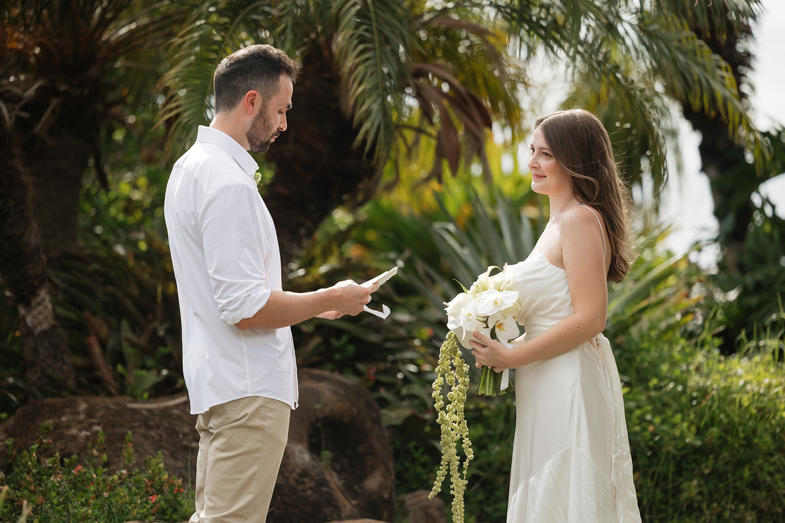 Roam Elopements, Maui Elopements, Bride and groom during an elopement ceremony with palm trees.