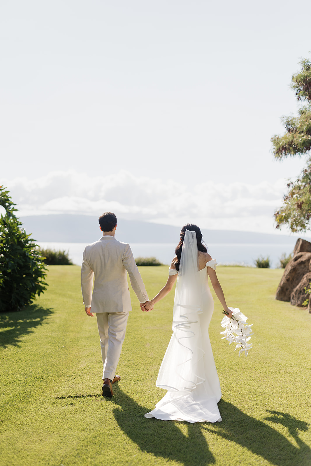 Roam Elopements, Maui Elopements, Bride and groom walking on lawn, elopement location.