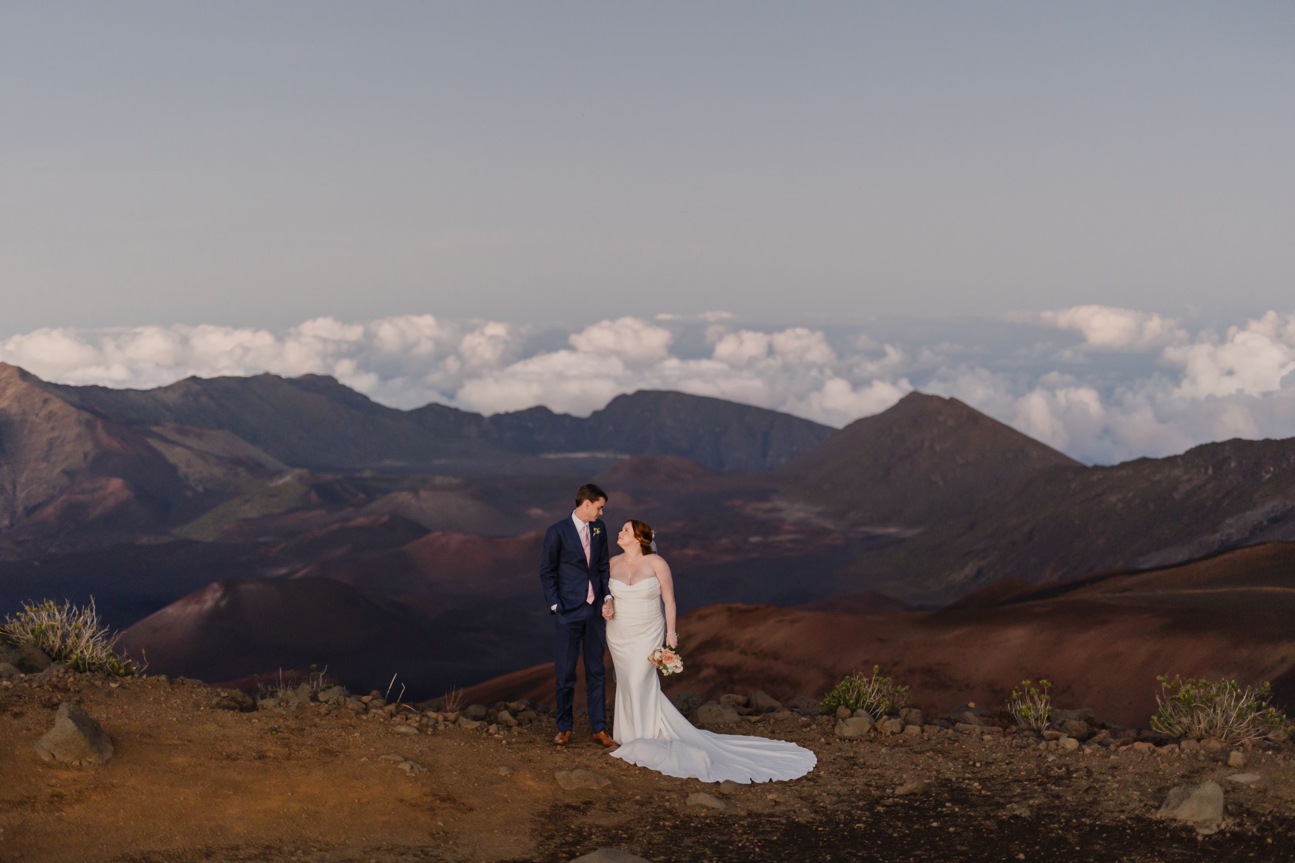 Liz Steve - Roam Elopements Roam Elopements, Maui Elopements, Happy couple, bride and groom, on a mountaintop overlooking a stunning landscape.