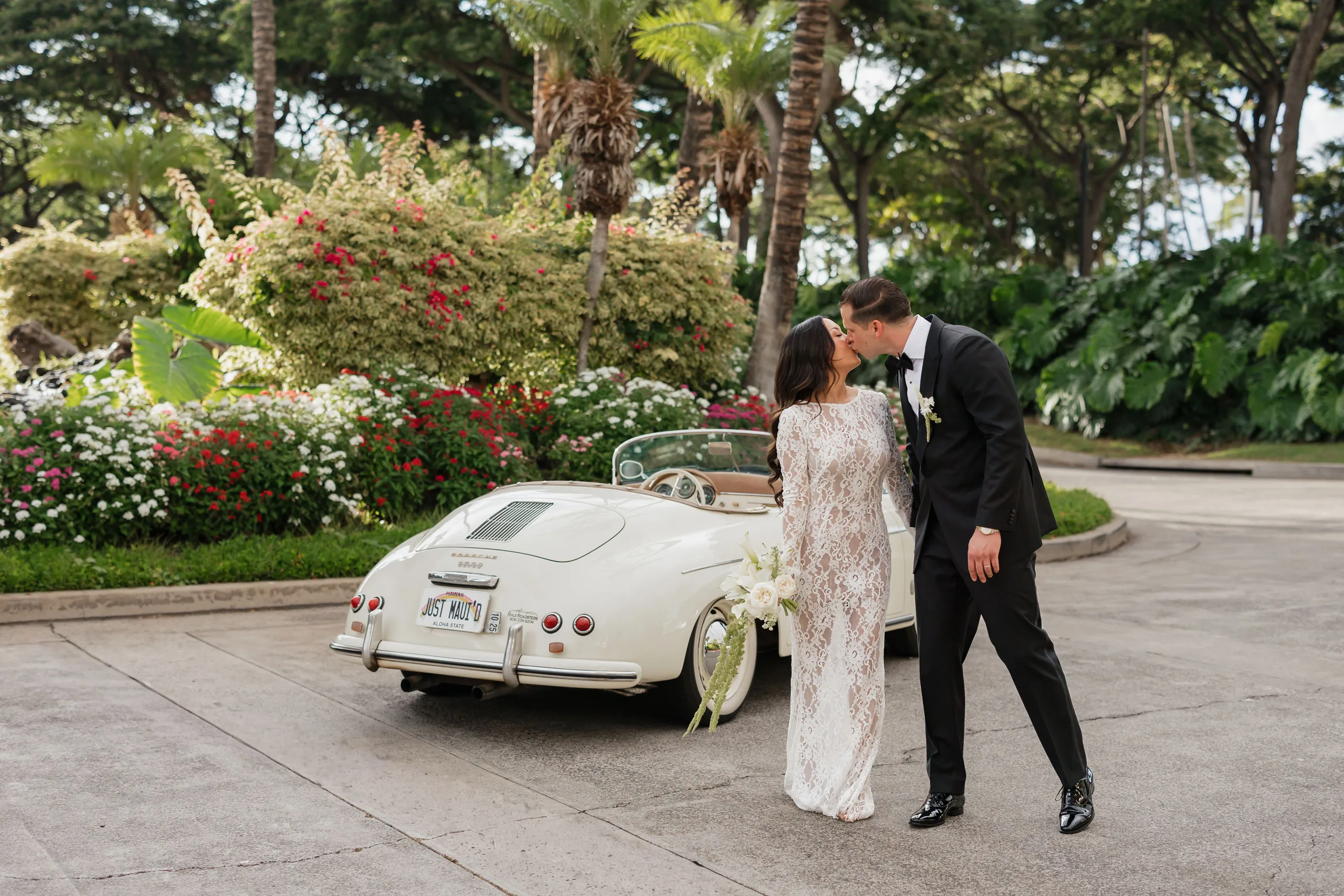 Roam Elopements, Maui Elopements, Bride and groom kissing by vintage Porsche with "Just Mau'd" license plate.
